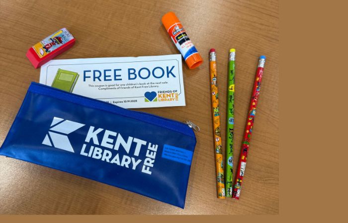 Blue pencil case with pencils, eraser and glue stick on table