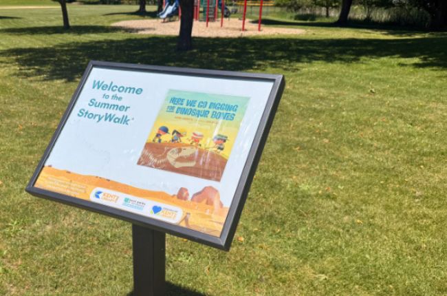Black frame in Al Lease Park that displays cover image for new storywalk title. 